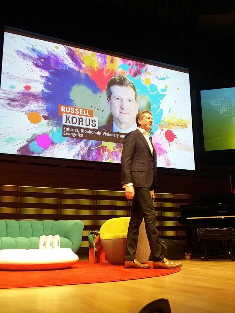 Russell Korus at IdeaCity with name on screen